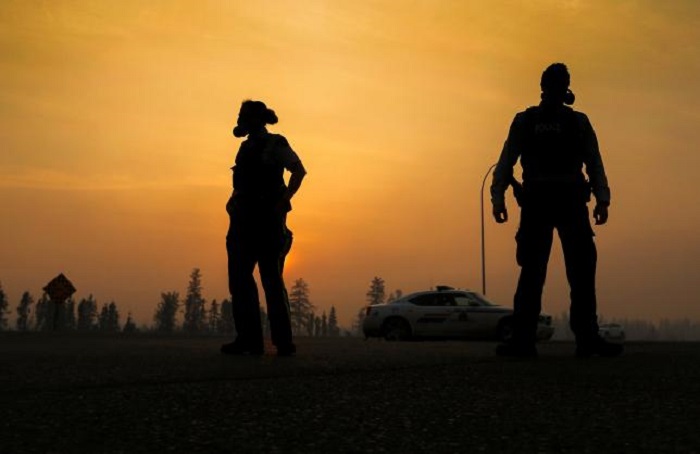 Convoy leads Canada fire evacuees through burning city to safety